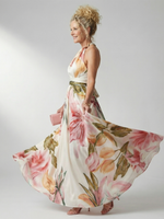 Pink-and-green floral halter maxi dress, side view with flowing chiffon-like skirt