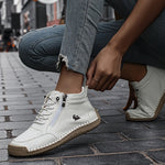 White ergonomic support sneaker worn with jeans; lace-up front and side zipper