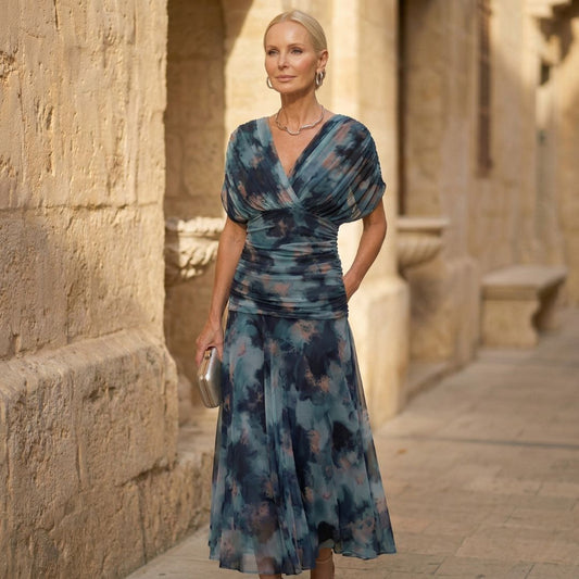 Blue watercolor evening dress with V-neck wrap bodice and short sleeves, midi length