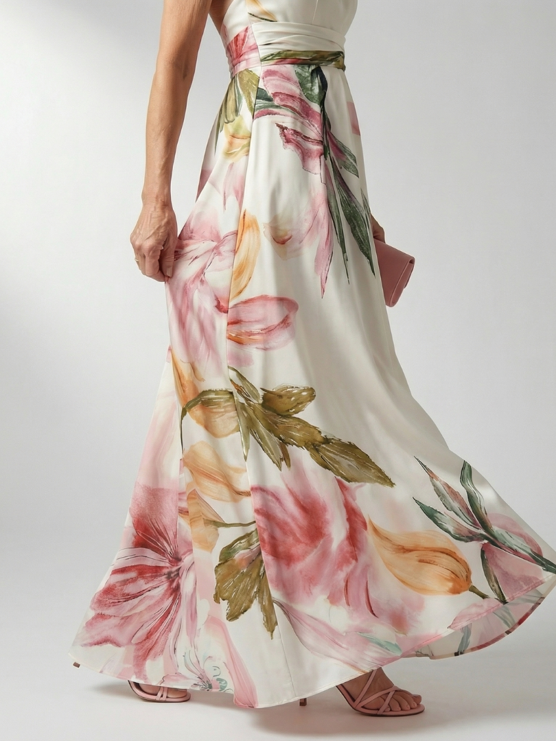 Pink floral maxi dress detail with belted waist and flowing skirt hem in print