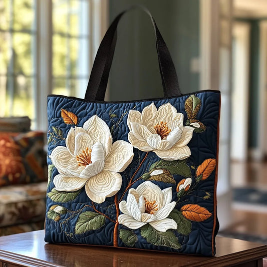 Quilted navy tote with black handles and white magnolia flower appliques
