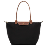 Black structured tote with tan leather handles, front flap pocket, gold hardware