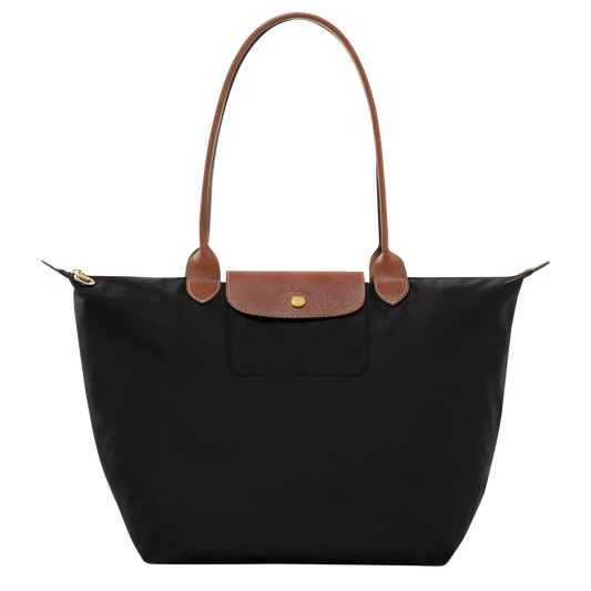 Black structured tote with tan leather handles, front flap pocket, gold hardware