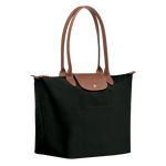 Black structured tote with tan leather handles, front flap, gold hardware