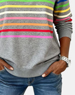 Gray quarter-zip sweatshirt with rainbow horizontal stripes and long striped sleeves