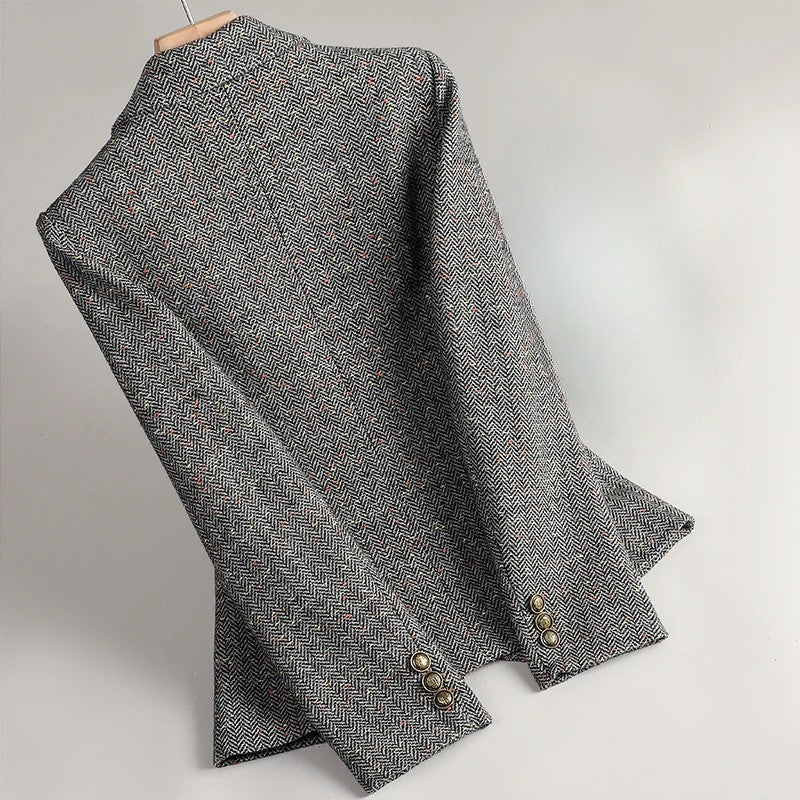 Gray tweed blazer sleeve and cuff details with gold-tone button embellishment