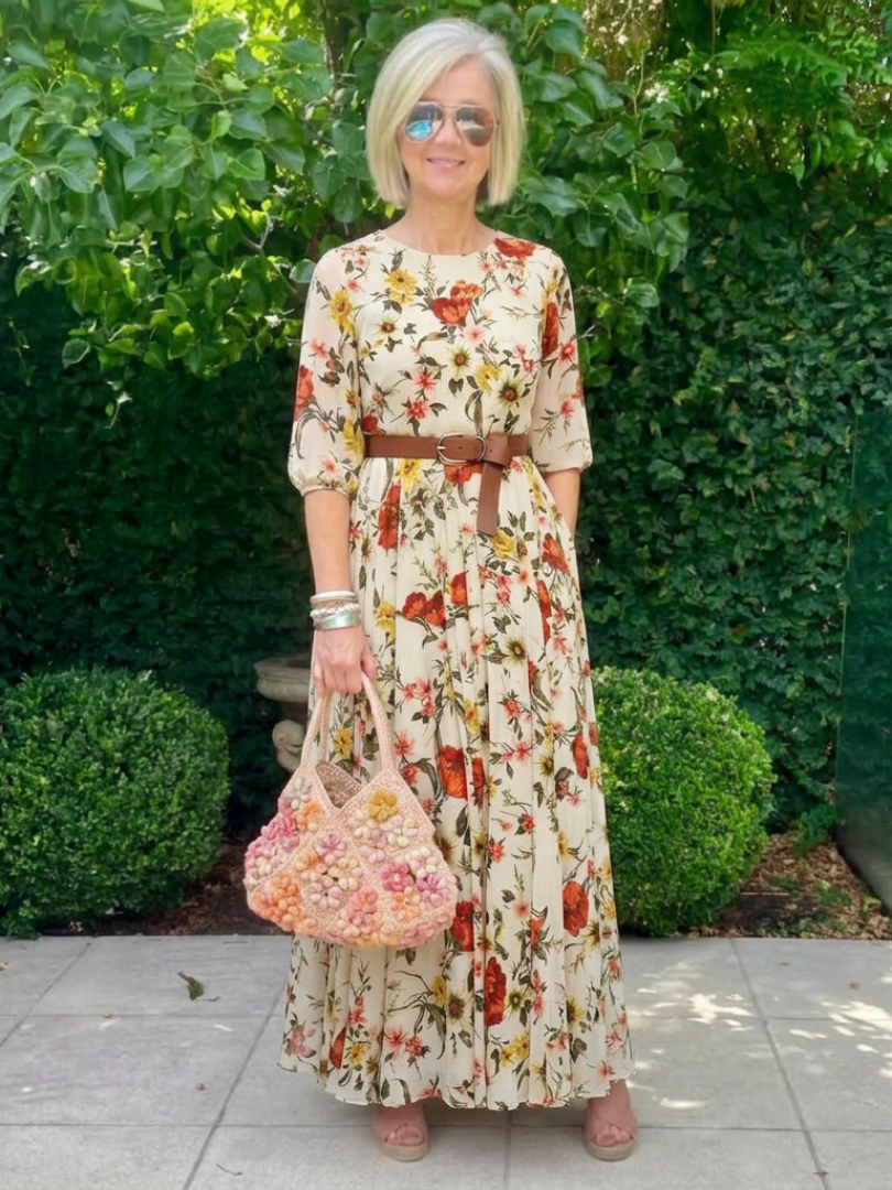 Floral belted maxi dress with round neck, three-quarter sleeves, and gathered tiered skirt