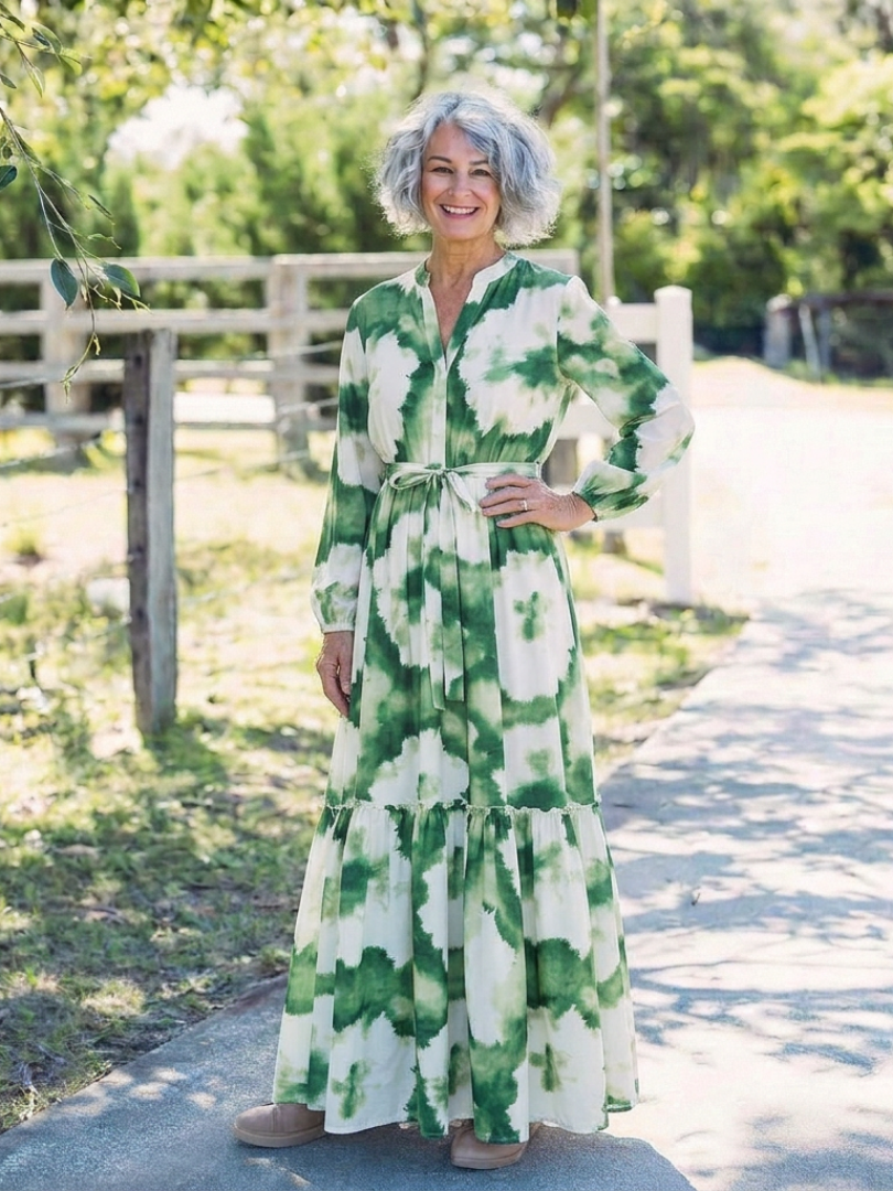Long-sleeve green and white tiered maxi dress with tie waist and layered skirt