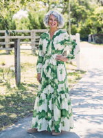 Long-sleeve green and white tiered maxi dress with tie waist and layered skirt