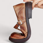 Brown Mary Jane shoe with ankle strap, square buckle, and thick cushioned sole