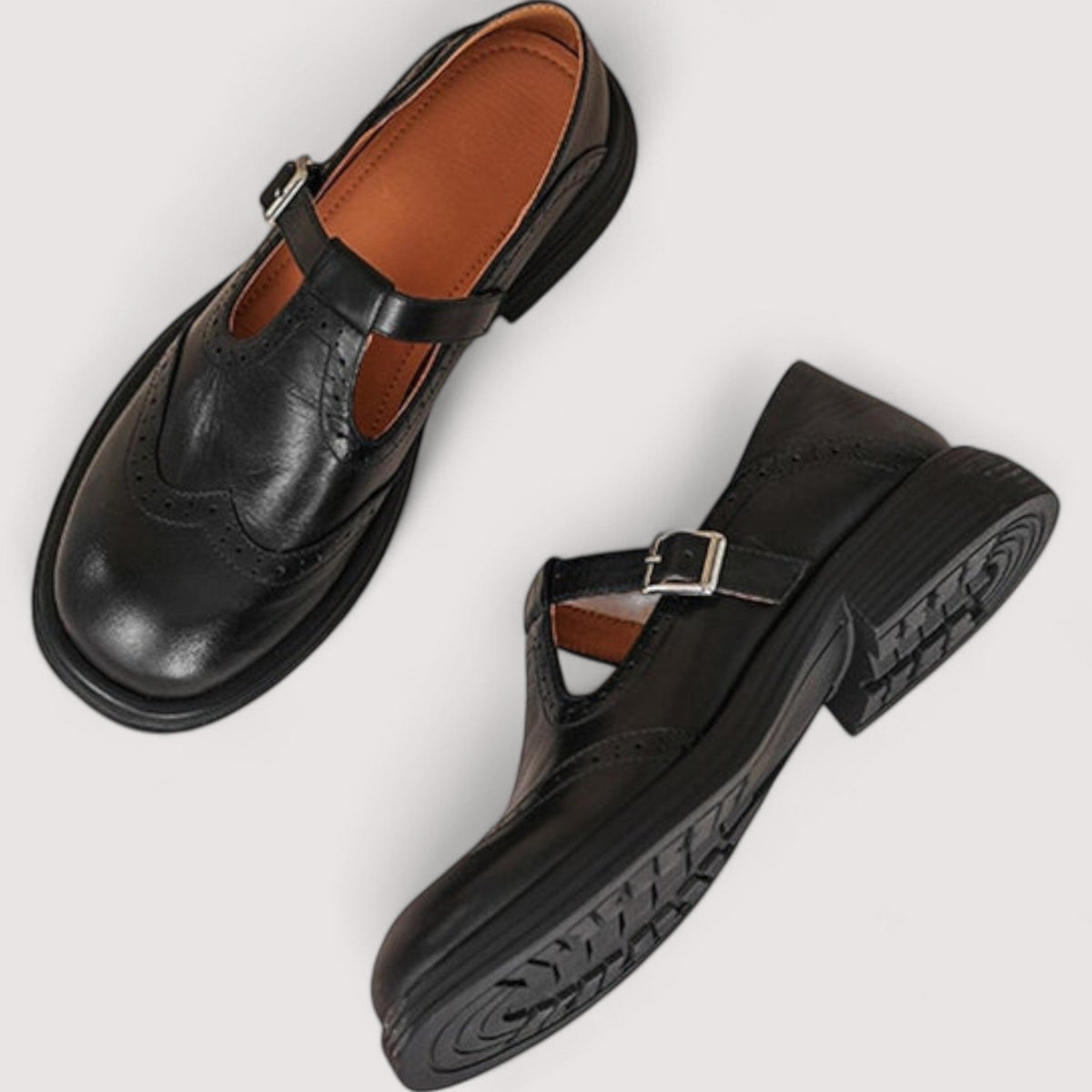 Black Mary Jane loafers with side buckle strap and textured tread outsole