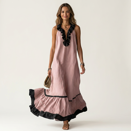 Pink sleeveless maxi dress with ruffle neckline and black contrast trim at hem