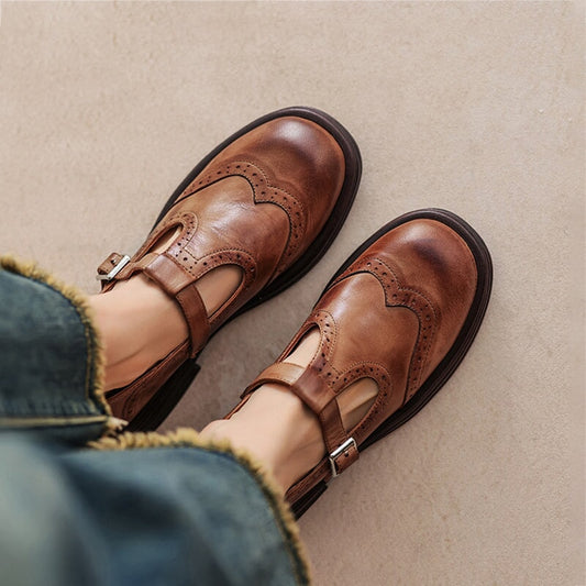 Brown leather Mary Jane shoes with buckle strap and cushioned, ridged sole