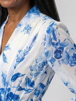 Blue floral print long sleeve wrap dress detail on cream fabric