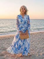 Blue floral maxi wrap dress with long sleeves, tied waist, V-neck