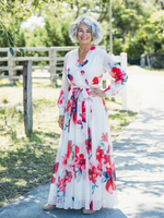 Red floral maxi wrap dress with long sleeves, tied waist, ankle-length skirt