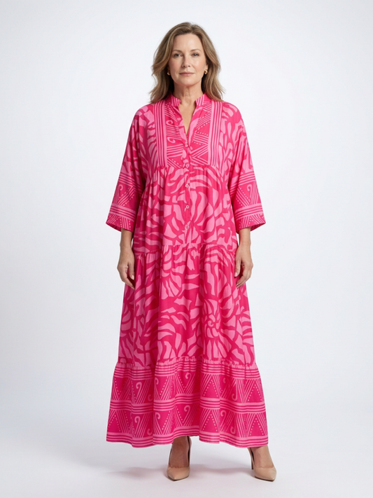 Pink midi button-front dress with V-neck and 3/4 sleeves, tiered skirt, patterned print.