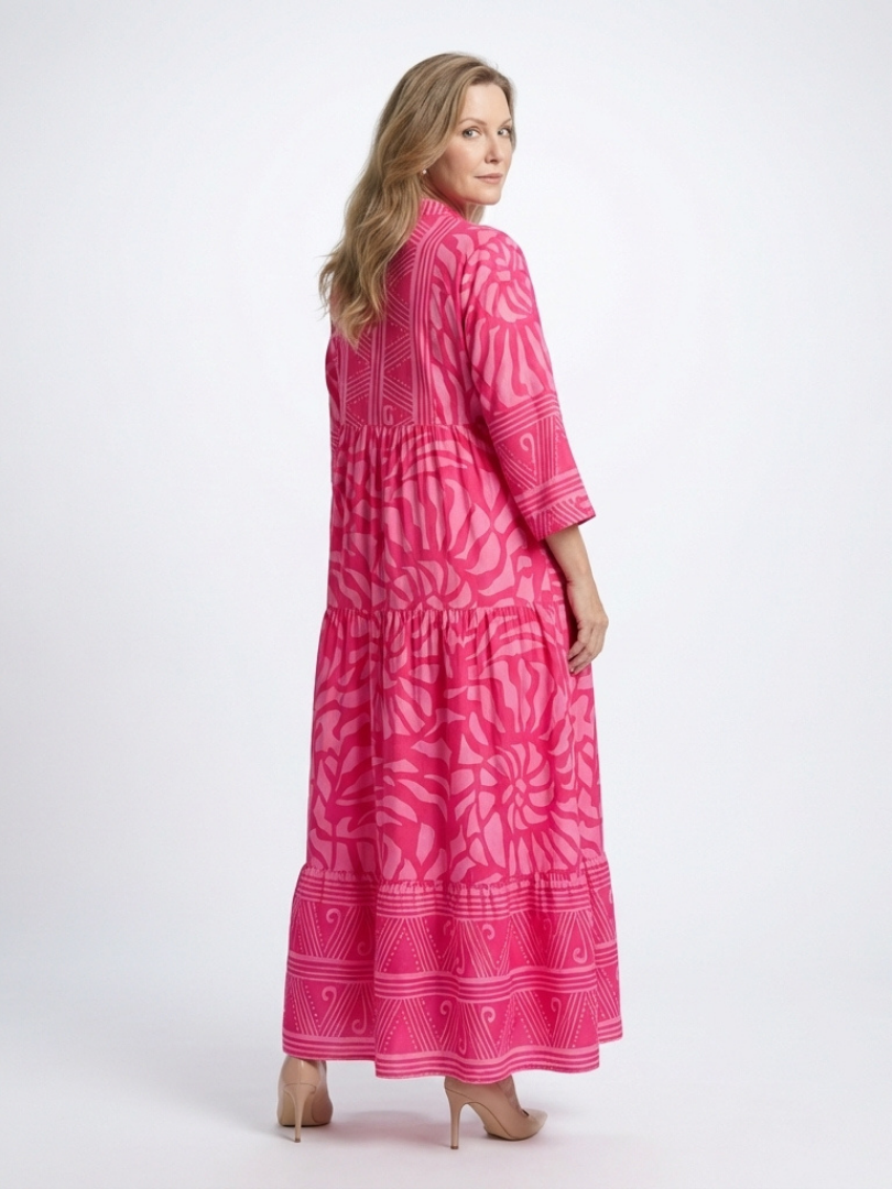 Pink midi button-front dress with V-neck, 3/4 sleeves, tiered skirt, patterned fabric.