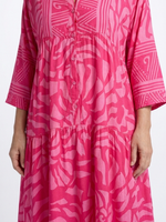 Pink button-front midi dress detail: V-neck placket with buttons and tiered bodice.