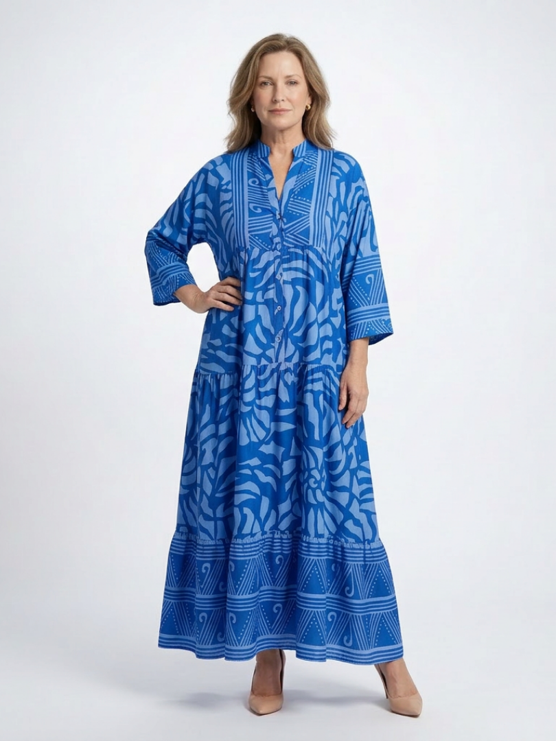 Blue midi button-front dress with V-neck and 3/4 sleeves, tiered skirt, abstract pattern.