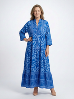 Blue midi button-front dress with V-neck and 3/4 sleeves, tiered skirt, abstract pattern.