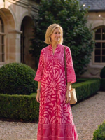 Pink midi button-front dress with V-neck and 3/4 sleeves, tiered skirt, bold geometric print.